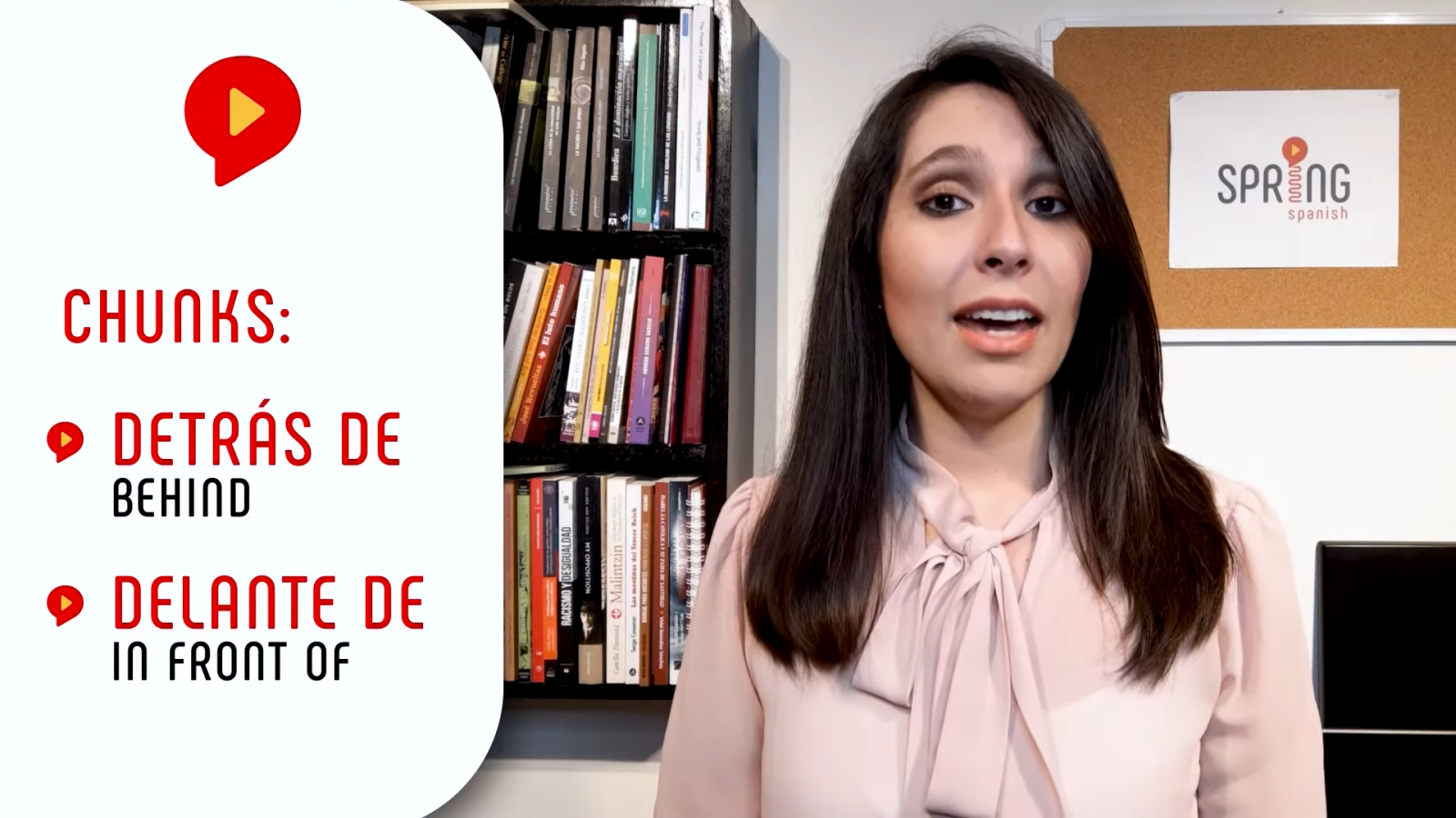 female teacher explaining prepositions of location in spanish