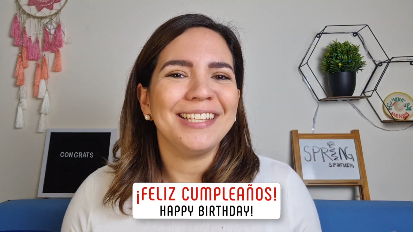 congratulations in spanish feliz cumpleanos text with female teacher in background